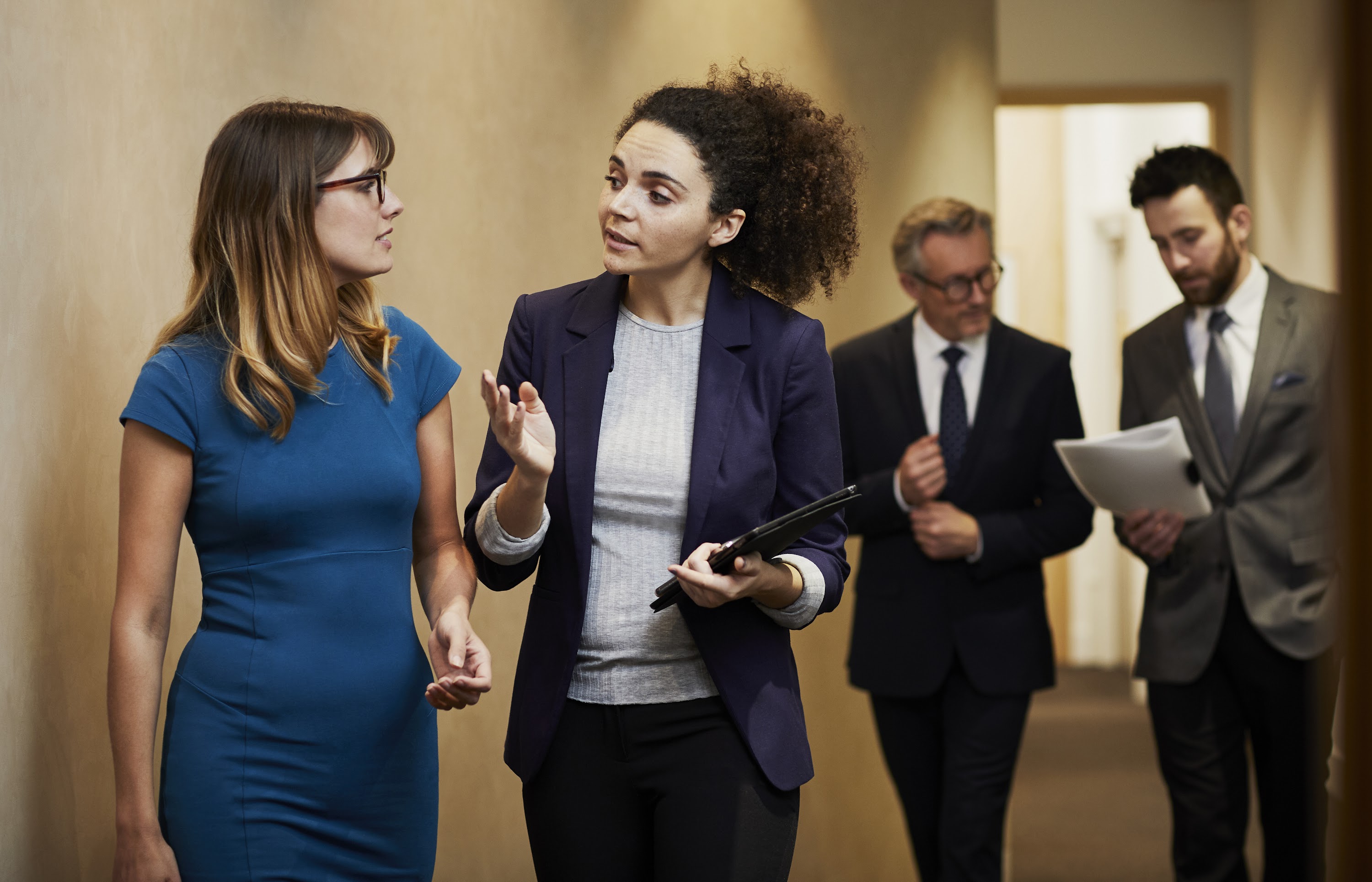 business-team-walking-and-talking-along-office-cor-2025-04-04-11-25-30-utc.jpg