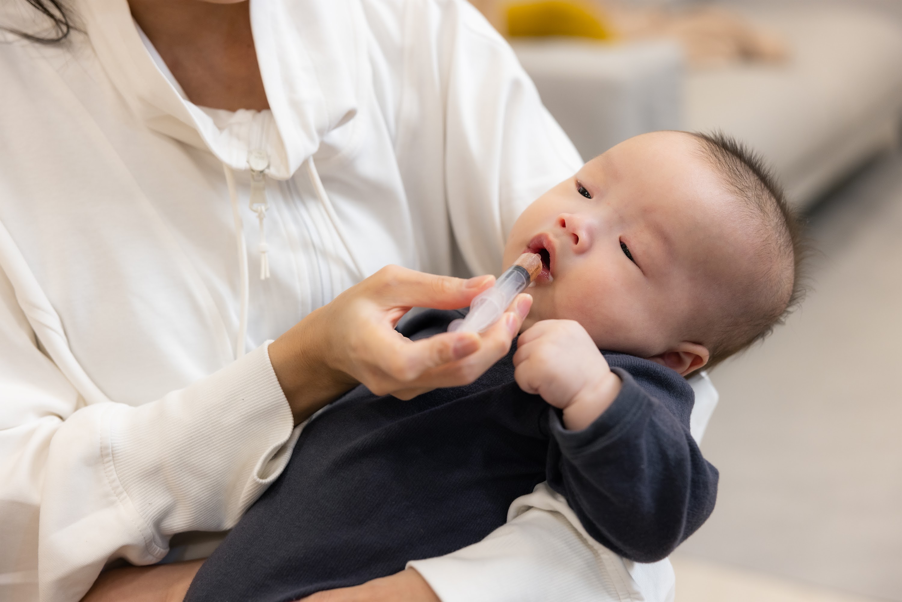 mother-helping-child-take-medicine-at-home-2025-04-01-00-19-22-utc.jpg