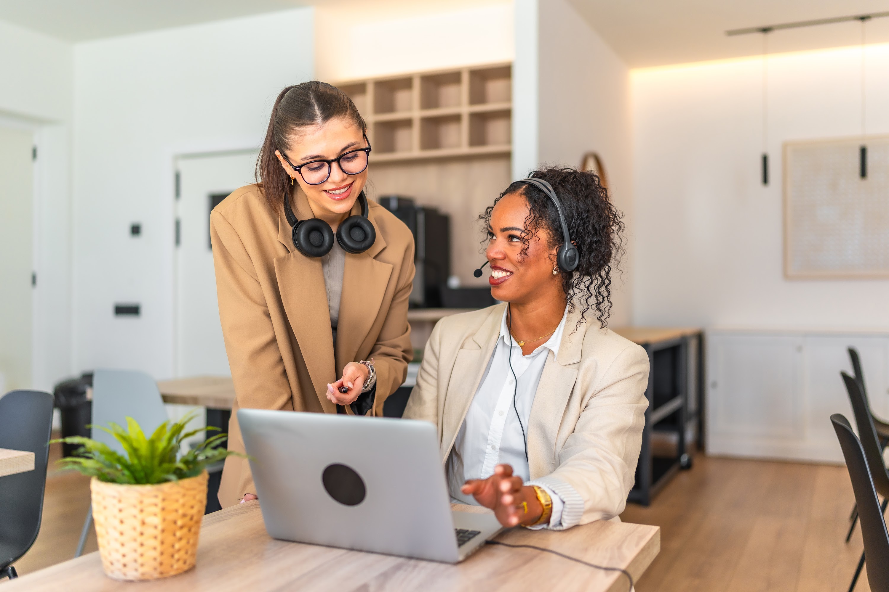 two-businesswomen-collaborating-on-laptop-in-moder-2025-04-29-18-01-16-utc.jpg