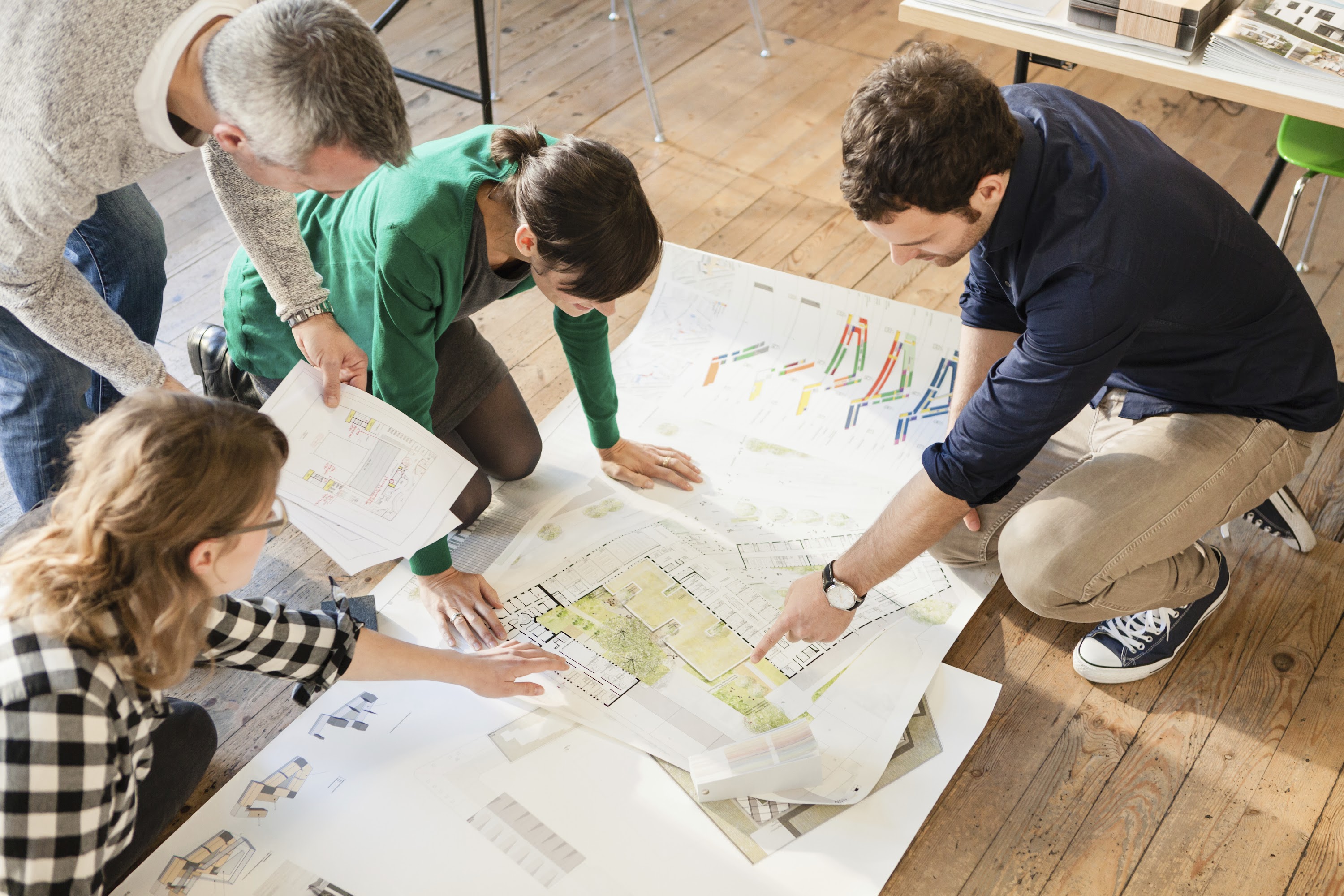 high-angle-view-of-architects-discussing-blueprint-2025-04-04-08-13-02-utc.jpg