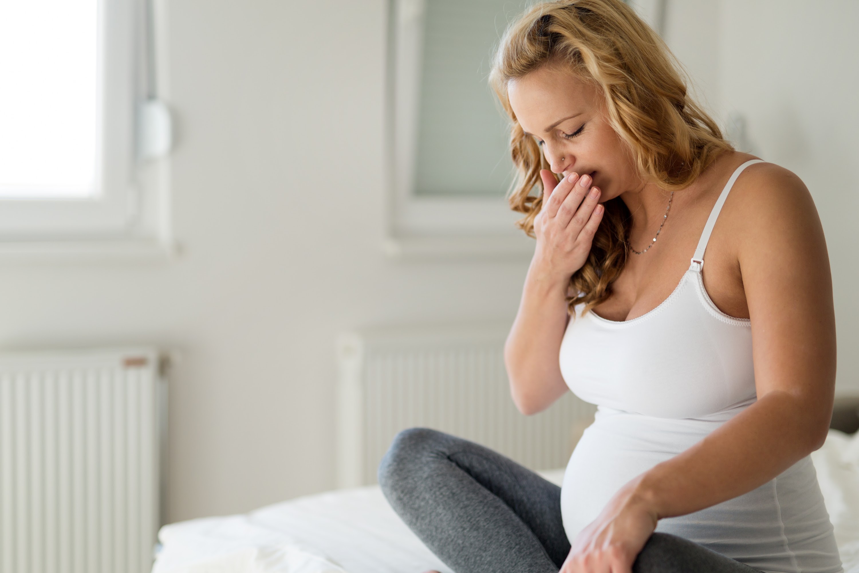 portrait-of-blonde-pregnant-woman-feeling-sick-2025-03-13-20-26-15-utc.jpg