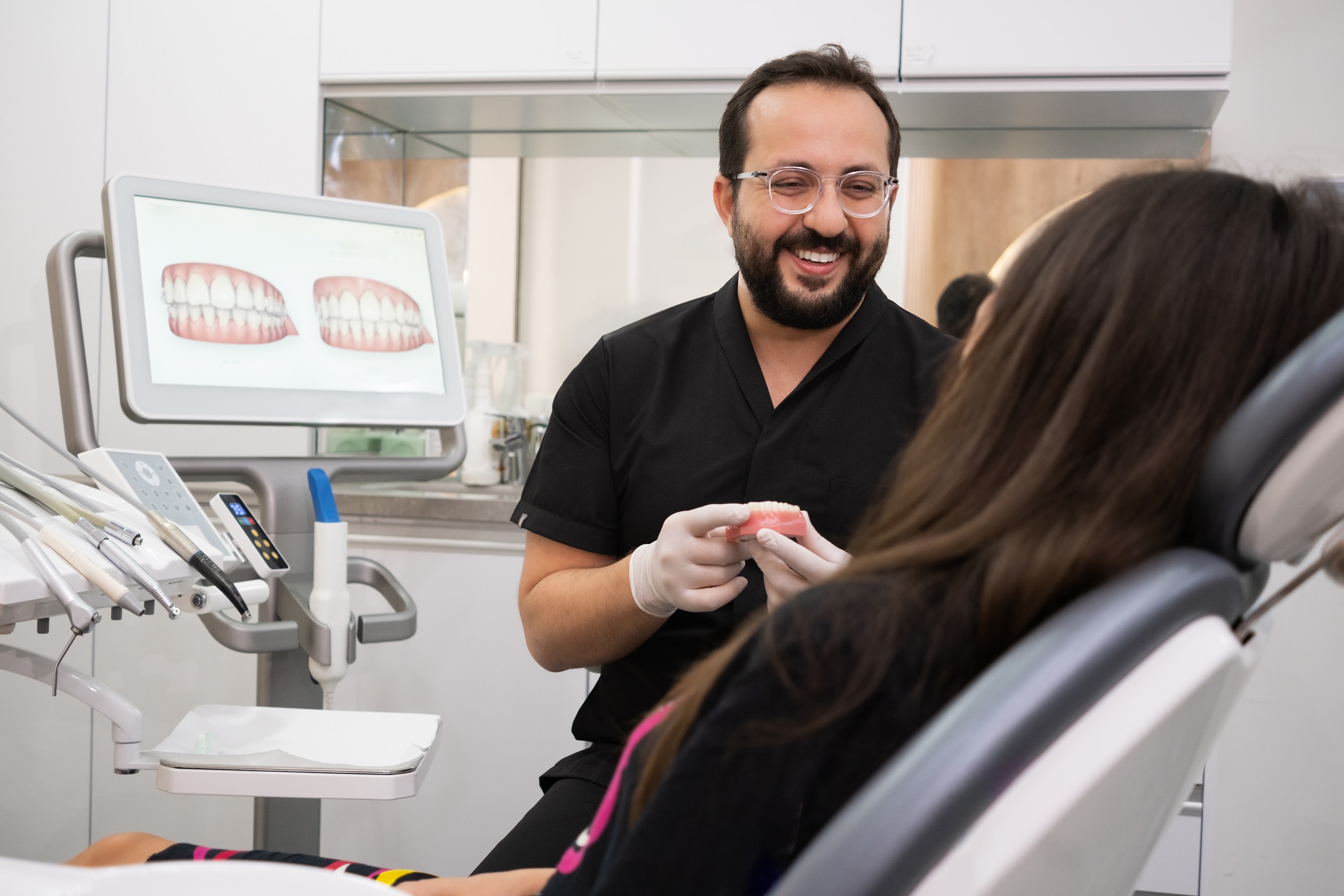 friendly-dentist-examining-woman-patient-teeth-wit-2024-11-29-14-34-55-utc.jpg