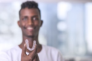 handsome-african-young-man-is-holding-an-invisalig-2025-01-07-18-24-15-utc.jpg