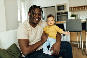 cute-baby-sitting-on-the-lap-enjoying-with-black-2024-10-18-04-34-07-utc.jpg