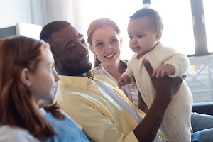 smiling-african-american-father-holding-infant-chi-2024-11-07-16-34-08-utc.jpg