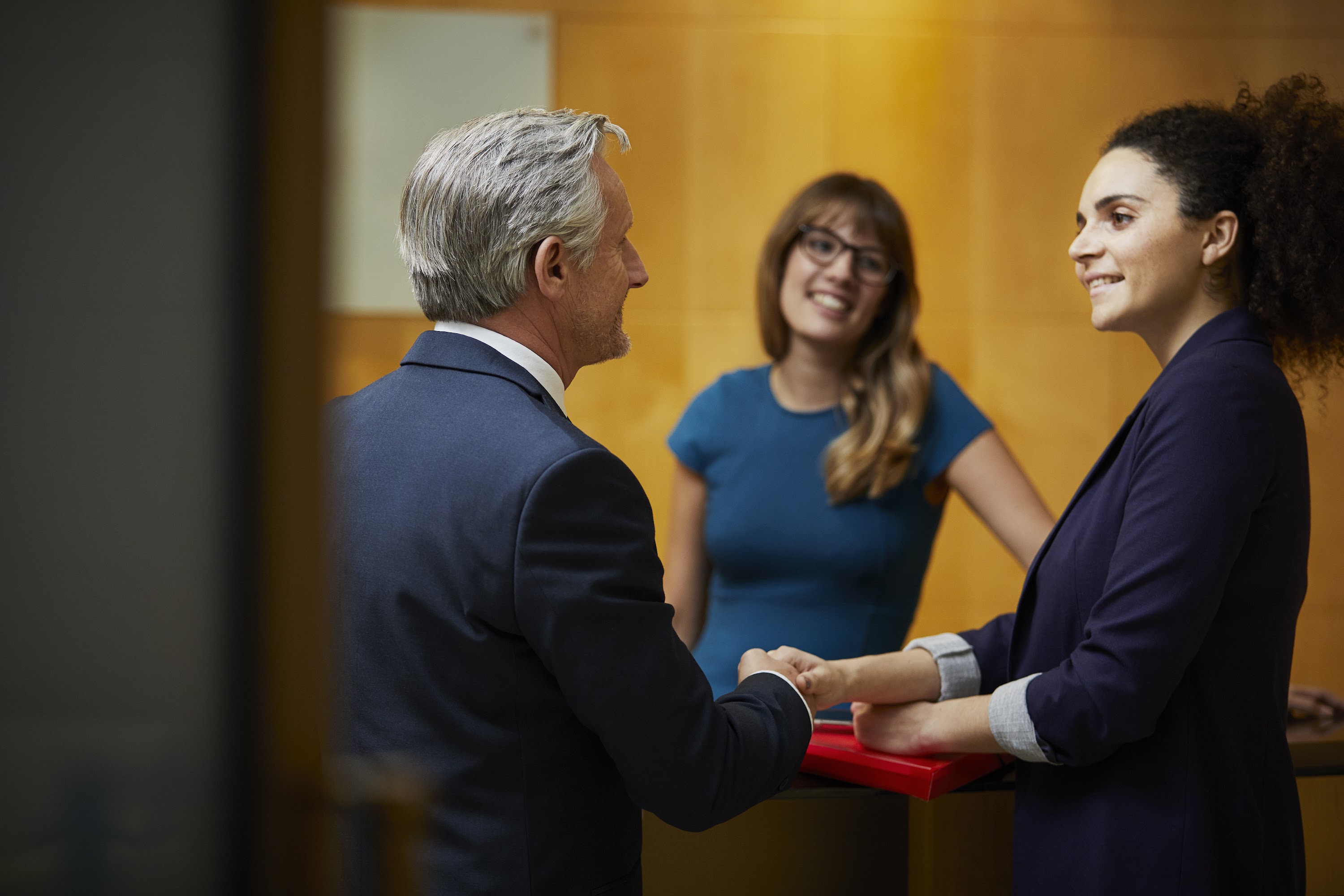 businesswoman-and-man-shaking-hands-in-reception-2025-04-04-11-25-23-utc.jpg