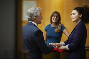 businesswoman-and-man-shaking-hands-in-reception-2025-04-04-11-25-23-utc.jpg