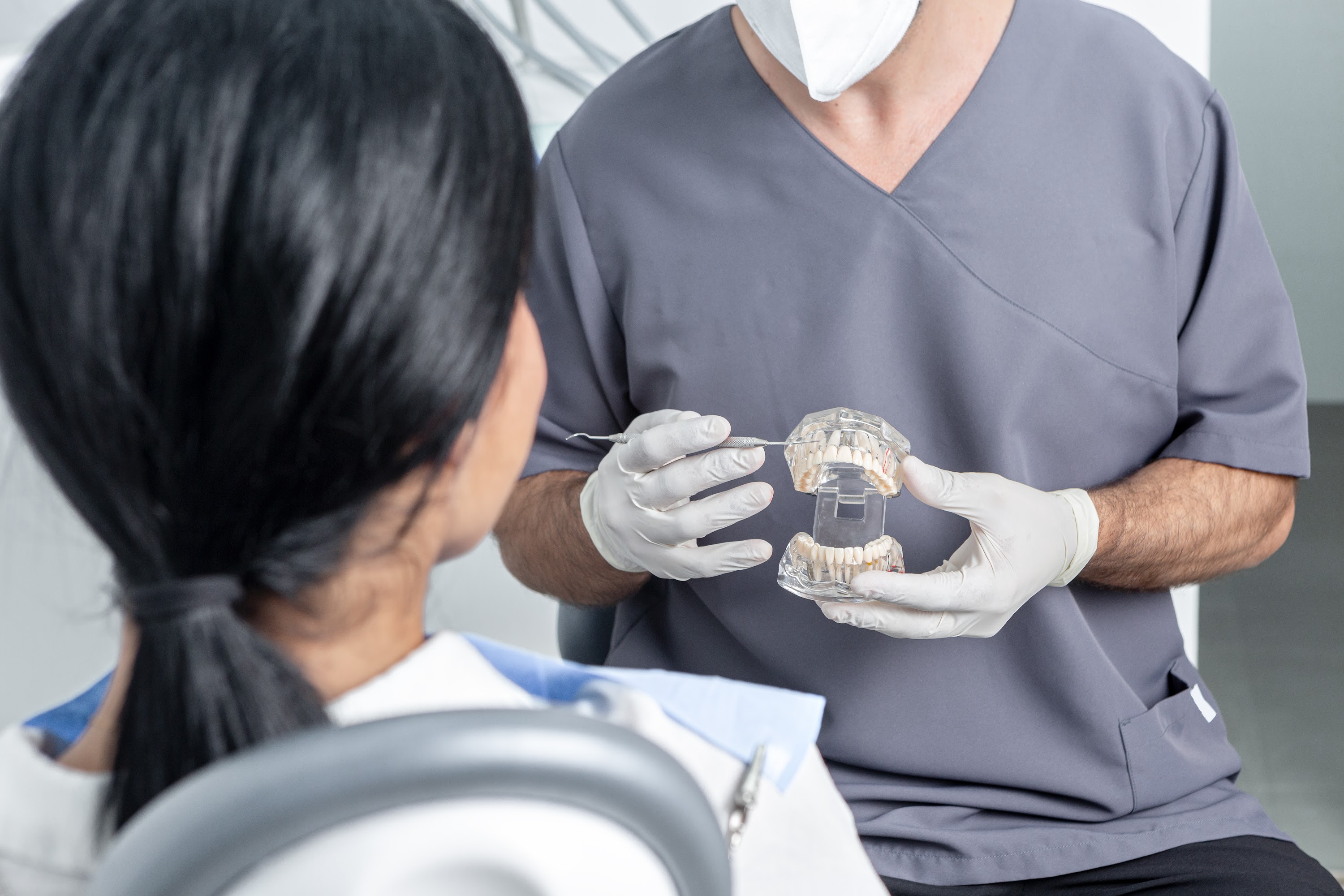dentist-showing-an-opened-dental-mould-to-a-patien-2025-03-05-19-24-45-utc.jpg