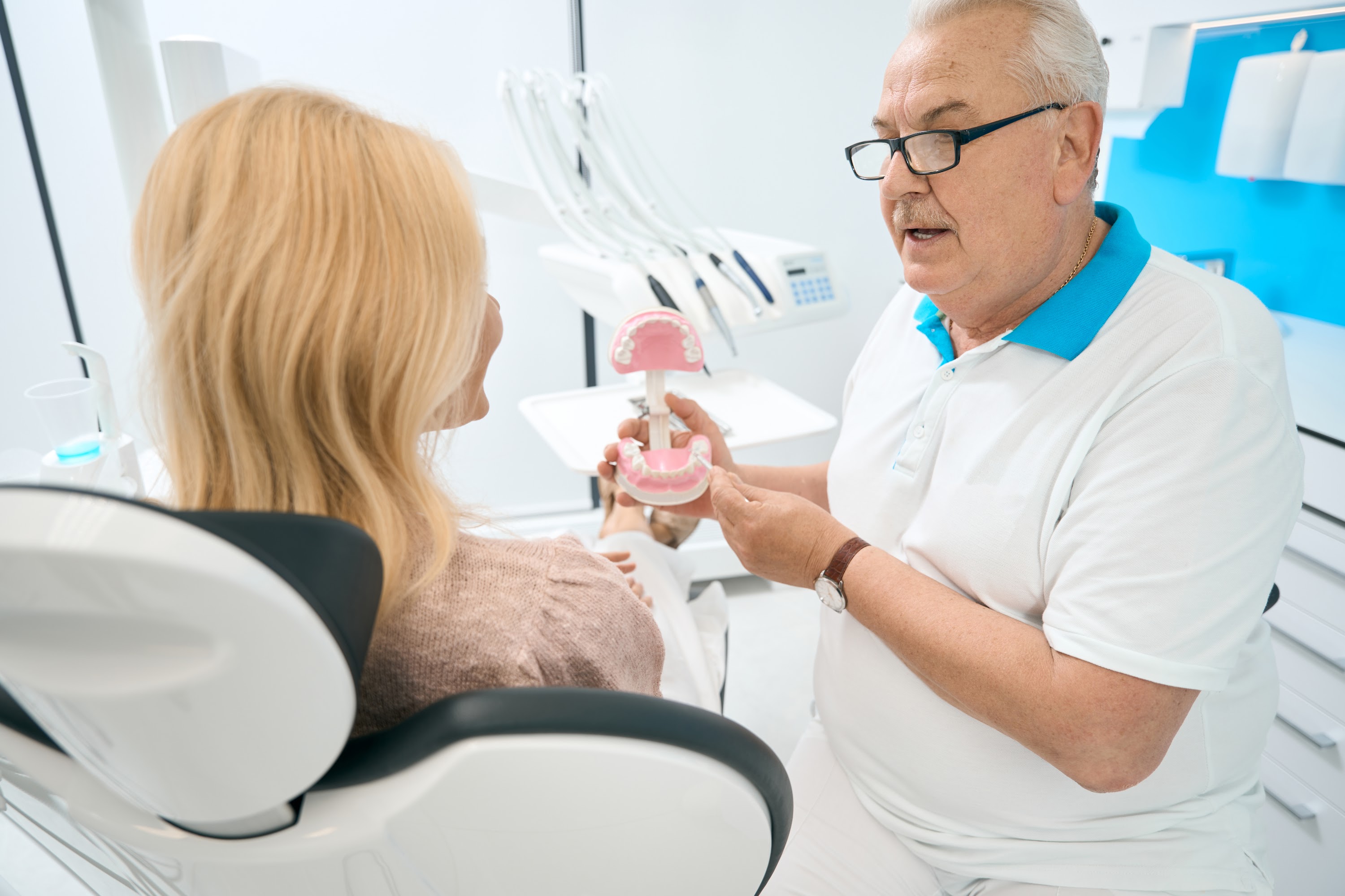 elderly-dentist-is-talking-with-female-in-medical-2024-10-18-17-45-05-utc.jpg