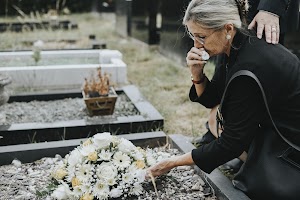 old-woman-laying-flowers-on-a-grave-2025-02-10-01-32-22-utc.jpg
