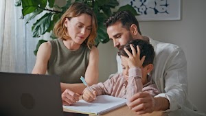 parents-kid-doing-homework-at-kitchen-table-closeu-2024-11-05-04-42-44-utc.jpg