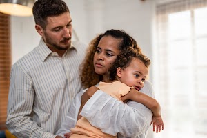 african-american-mother-tosses-young-baby-girl-up-2025-04-02-16-36-44-utc.jpg