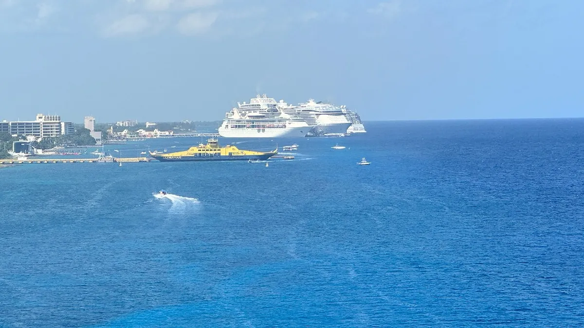 Aerial view of cruise ships docked at Cozumel cruise port terminals with the Caribbean sea behind them