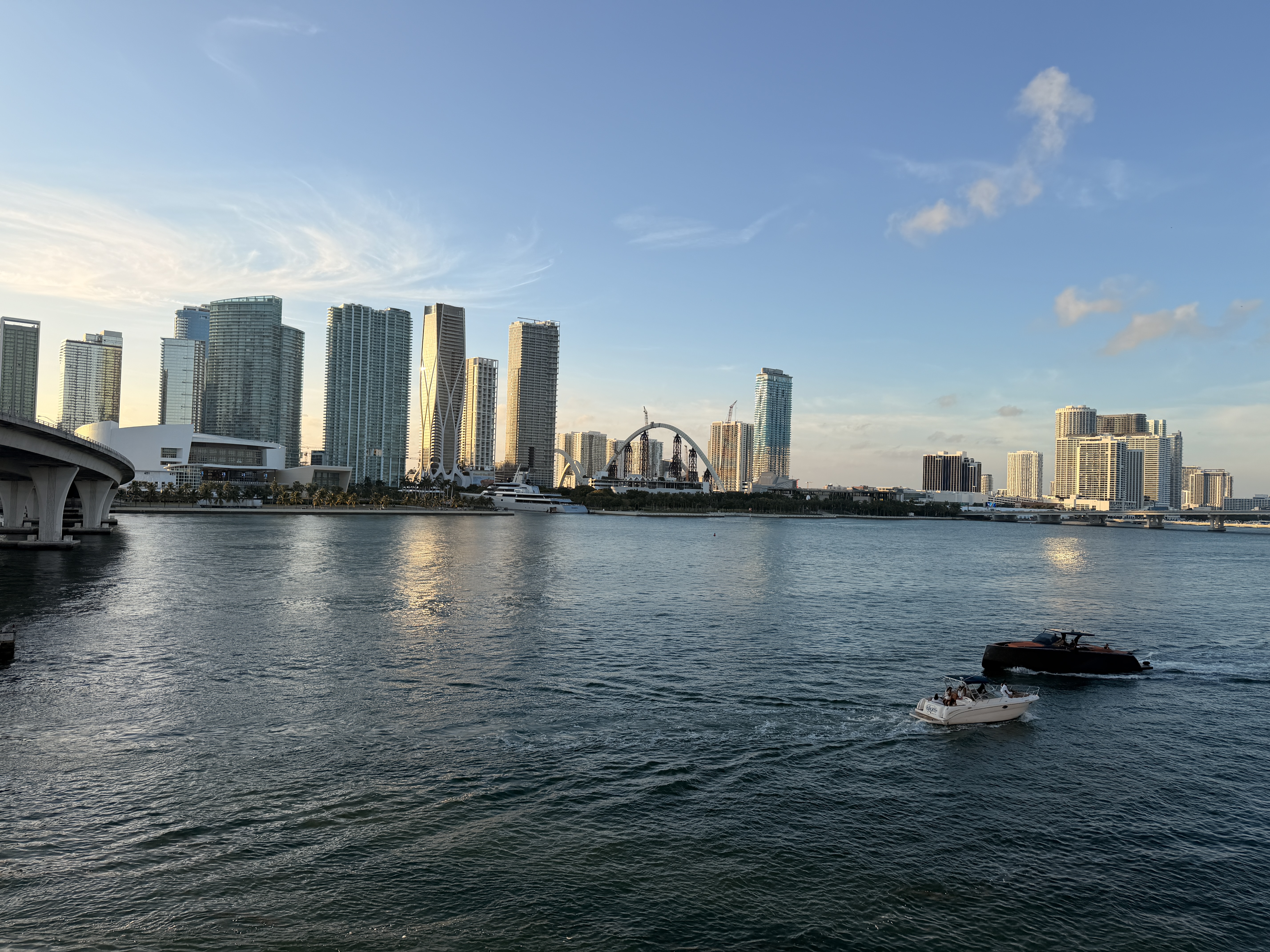 Wide horizontal of cruise ship docked at Miami port with downtown skyline behind it