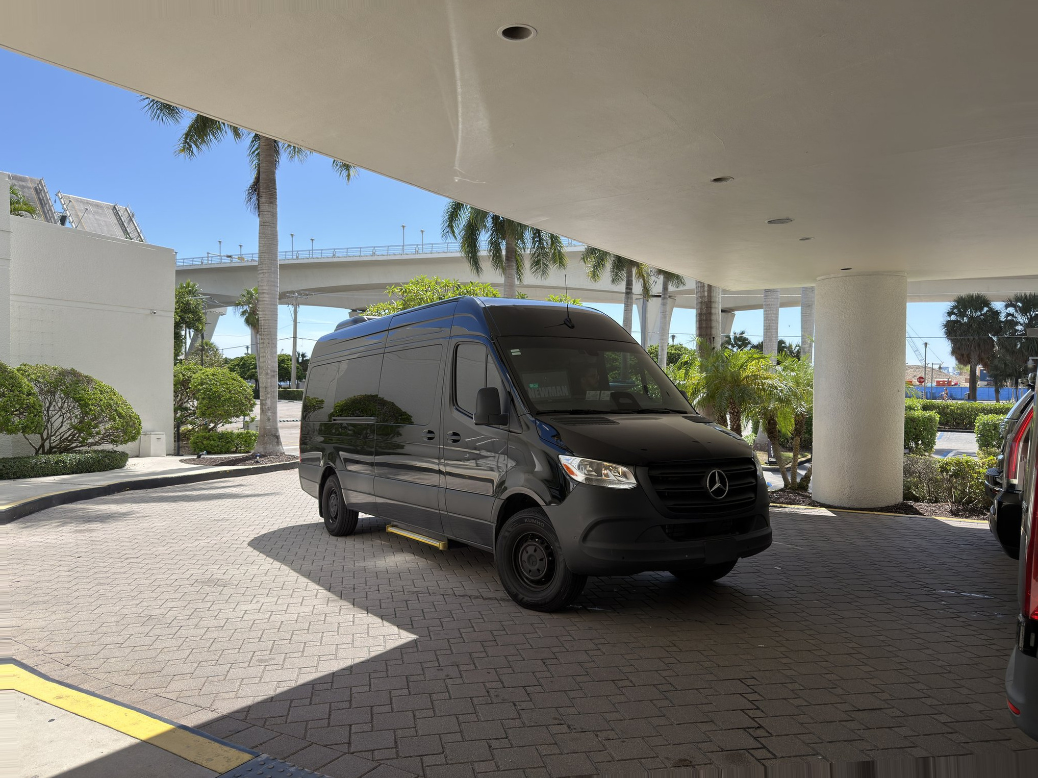 Hector with his black Suburban or Mercedes Sprinter, professional driver portrait horizontal