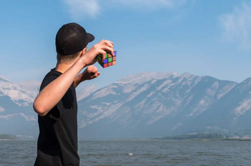 Man Throwing a Rubik's cube Into a Lake