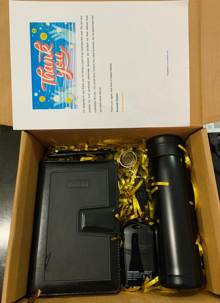 An early Qart gift box with a handwritten thank-you note, diary, pen, and power bank