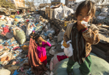 Solid waste management in Nepal Picture of a kid and his mother in solid waste land in Nepal